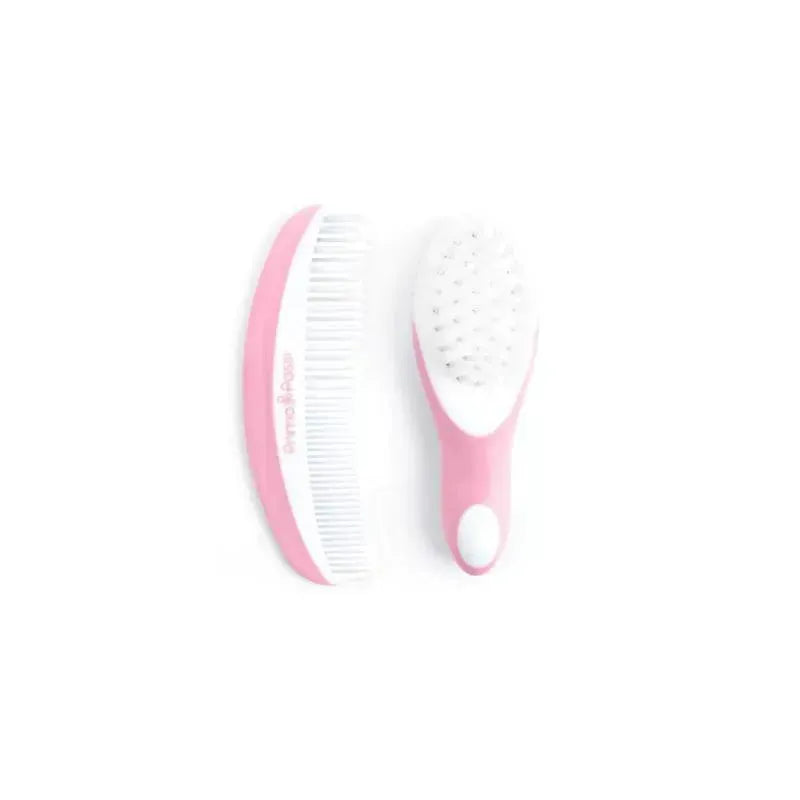Primo Passi pink baby comb and brush set featuring a soft-bristled brush and a fine-toothed comb.