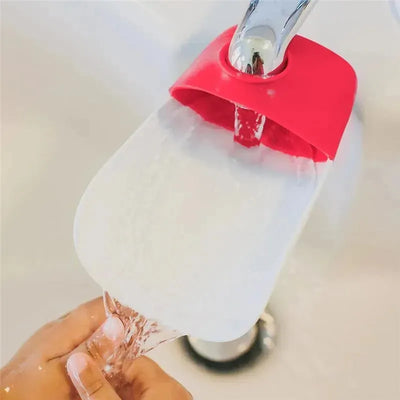 Faucet extender in Flash Bulb Fuchsia, enhancing water flow for easier access, with water running from the faucet.