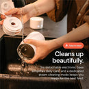 Portable milk warmer being cleaned under running water, emphasizing its easy-to-clean features and detachable electronic base.