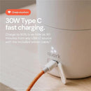 Quark BuubiBottle Portable Milk Warmer PRO showing a USB-C port with an orange woven charging cable, highlighting fast charging capabilities.