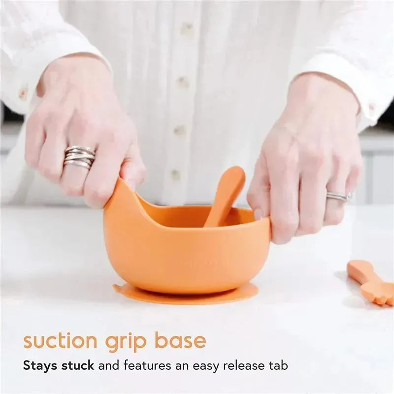 Silicone baby feeding set featuring an orange bowl with a suction grip base and a matching spoon.