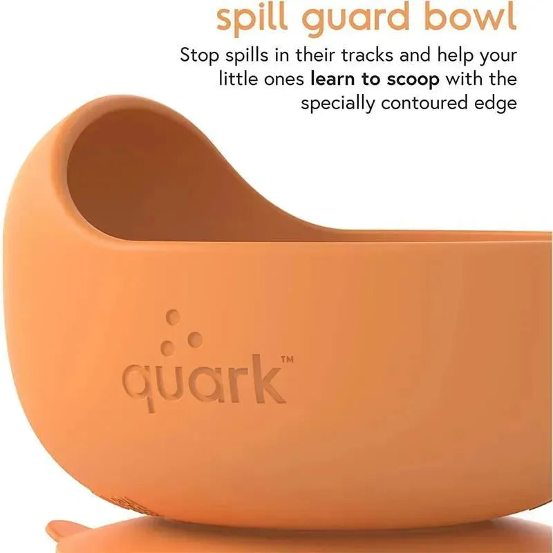 Silicone spill guard bowl in orange by Quark, designed to help babies learn to scoop with its contoured edge.