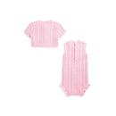 Sleeveless pink cotton sweater shortall and matching cardigan with cable knit pattern.