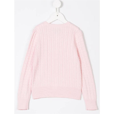 Cable-knit cotton cardigan in hint of pink, featuring long sleeves and ribbed hem, displayed on a hanger.