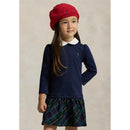 Long-sleeve navy shirt dress with a white collar and plaid skirt, worn by a girl with long hair and a red beanie.