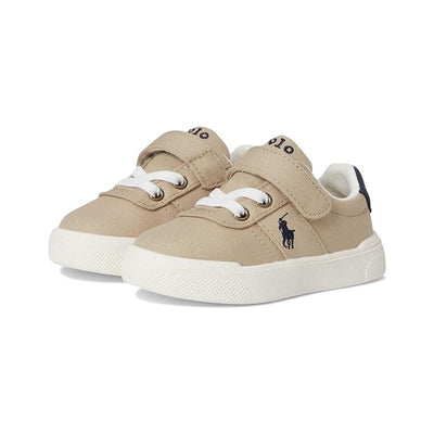 Beige toddler sneakers with white laces and a navy blue logo, featuring a Velcro strap for easy wear.