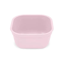 Reusable square bowl in ice pink, designed for versatile use, featuring a smooth surface and rounded edges.