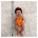 African American full silicone reborn baby doll named Arianna, dressed in an orange outfit with a matching headband.