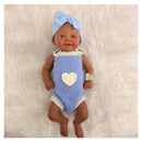 Reborn baby doll, African American, bald, wearing a blue outfit with a heart and a matching bow headband.