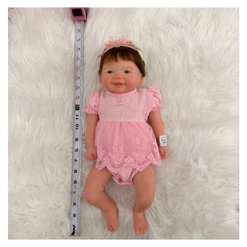 Reborn Baby Doll Vivienne, featuring a full silicone body, dressed in a pink outfit with lace detailing.