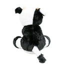 Plush toy cow with a black and white pattern, seated with a tail and ears visible from the back.