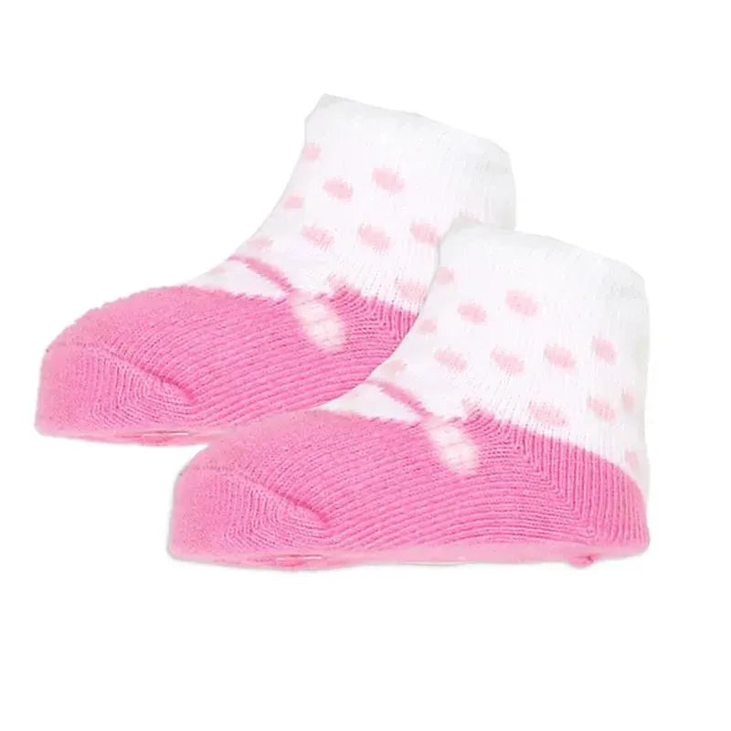 Pink and white crew socks with polka dots, designed for children, showing soft, ribbed fabric.