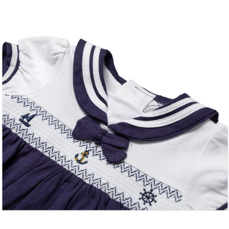 Navy nautical-themed dress set for baby girls featuring a collared top, embroidered designs, and a bow detail.
