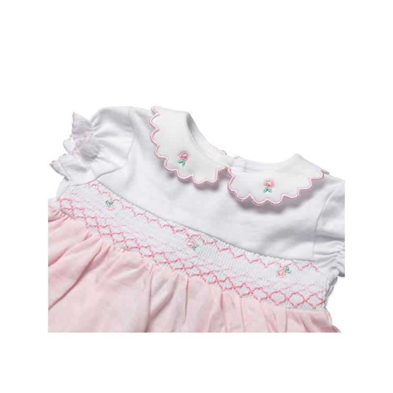 Baby girls dress set by Rose Textiles featuring a pink floral design, white bodice with scalloped collar, and decorative embroidery.