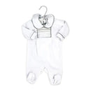 Neutral velour coverall in white with a smocked chest and large collar, designed for infants, displayed on a hanger.