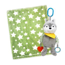 Plush activity toy shaped like a wolf with a yellow bandana, attached to a sage green star-patterned blanket.