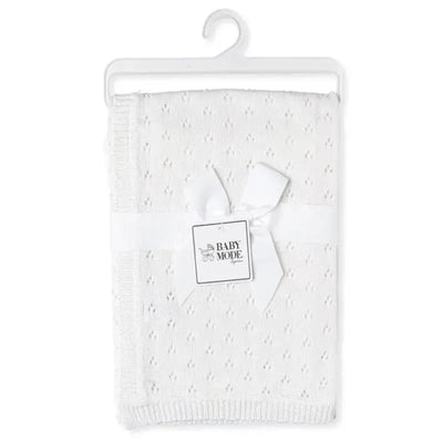 Pointelle knit white blanket tied with a ribbon and tag, designed for babies, featuring a delicate texture.