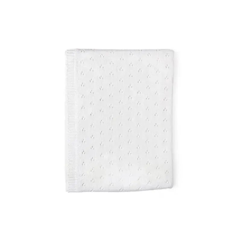 Pointelle knit blanket in white, featuring textured stitching and a soft finish, ideal for cozying up or decoration.