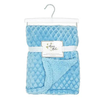Two-layer plush blanket in soft blue, featuring a textured diamond pattern and a fluffy underside, displayed on a hanger.