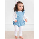 Light wash denim overall romper with ruffles worn by a baby girl, paired with white leggings featuring pink bows.