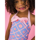 Baby girl wearing a lilac seersucker one-piece rash guard with a pink bow and colorful sea-themed patterns.