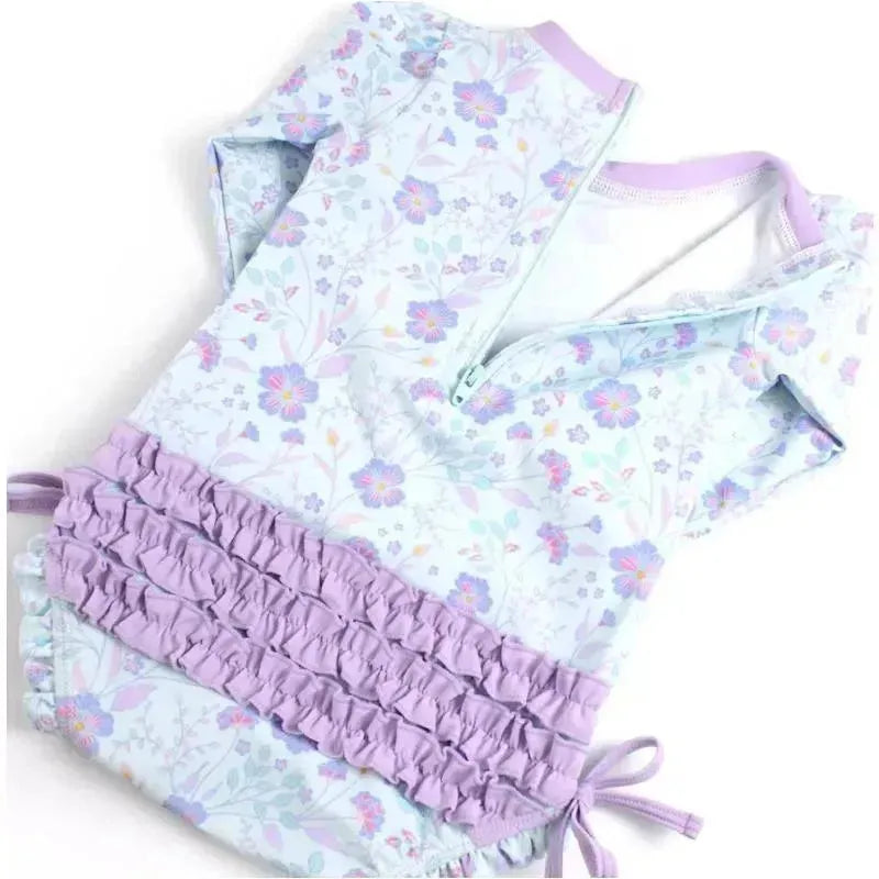 Long sleeve one-piece rash guard by Rufflebutts featuring a floral pattern in pastel colors and ruffled lavender accents.