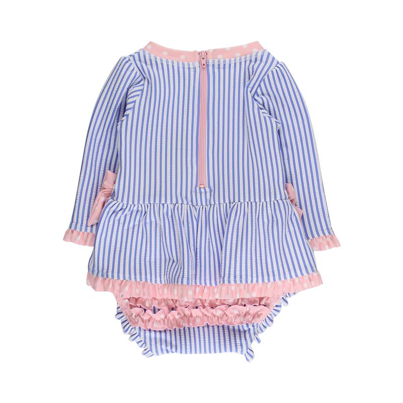 Periwinkle blue long sleeve one-piece rash guard swimsuit for girls with a peplum, zipper, and pink accents.