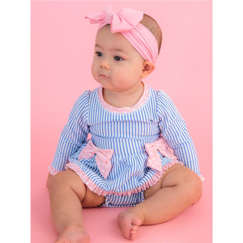 Periwinkle blue seersucker long sleeve one-piece swimsuit with pink bows, worn by a baby sitting against a pink background.