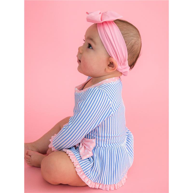 Long sleeve periwinkle blue seersucker swimsuit with a bow peplum detail, worn by a baby girl with a pink headband.
