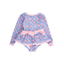 Long sleeve, peplum-style swimsuit for girls featuring a tropical print with pink accents and bows.
