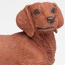 Dachshund figurine made of plastic, featuring textured fur details and a smiling expression, measuring 3.75 inches.