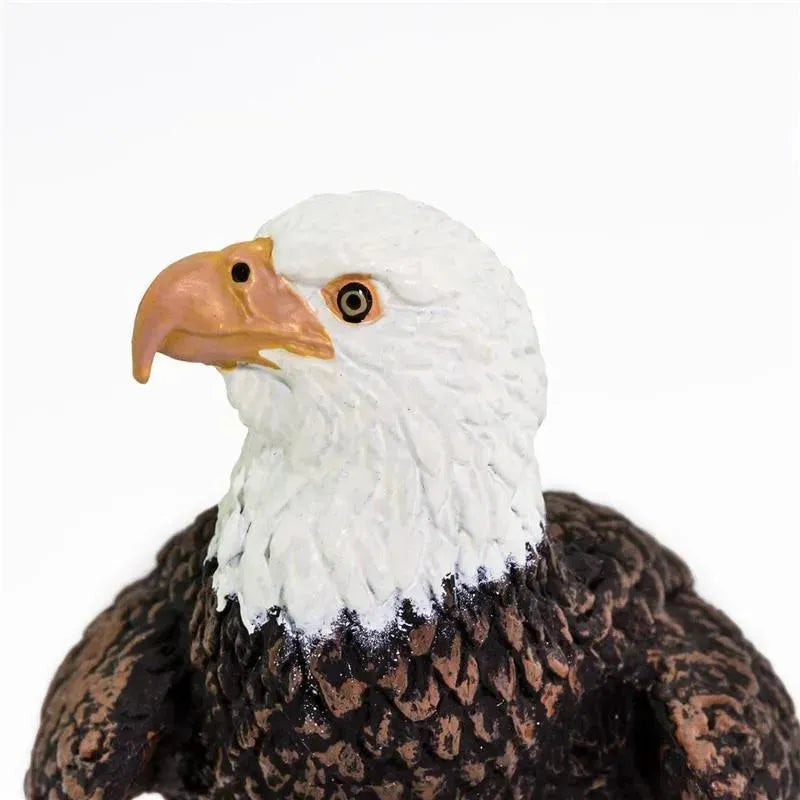 Bald eagle figurine featuring detailed feathers, a striking white head, and a yellow beak.