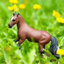 Thoroughbred horse figurine by Safari Ltd., detailed and realistic, set against green grass and yellow flowers.