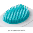 Cradle cap brush and comb with a soft, rubber bristle head in blue and white, designed for gentle scalp care.
