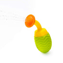 Bright green bath toy resembling a pineapple, featuring a yellow top and an orange spout, sprays water.