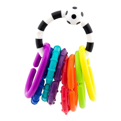 Colorful plastic ring toy with multiple links in bright colors, featuring a black and white polka dot handle.