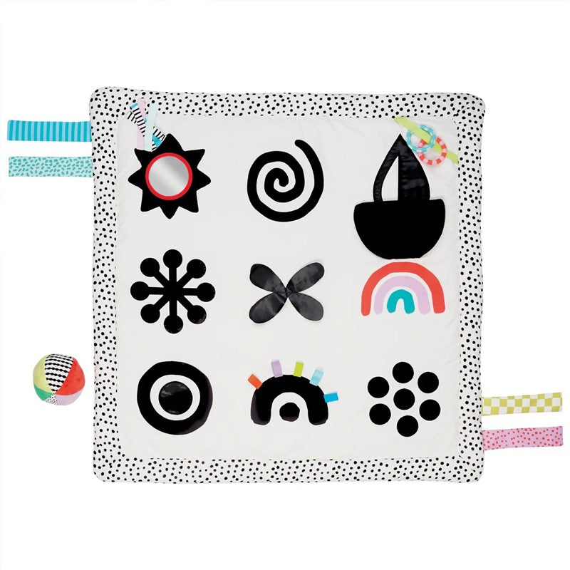 Interactive black and white sensory play mat featuring various patterns and textures, with colorful tags and a small ball.