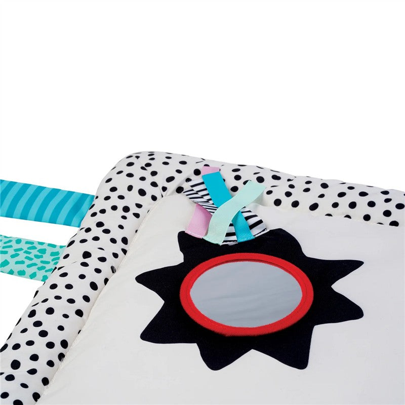 Sassy Wimmer Seek & Explore Mat featuring a soft, padded surface with colorful patterns, a mirror, and various textured ribbons.