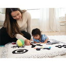 Mom and baby play on a patterned mat featuring colorful toys, encouraging exploration and sensory development.
