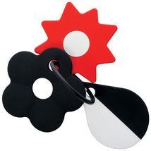 Colorful silicone shape toys including a red star, black flower, and a black and white teardrop, designed for sensory exploration.