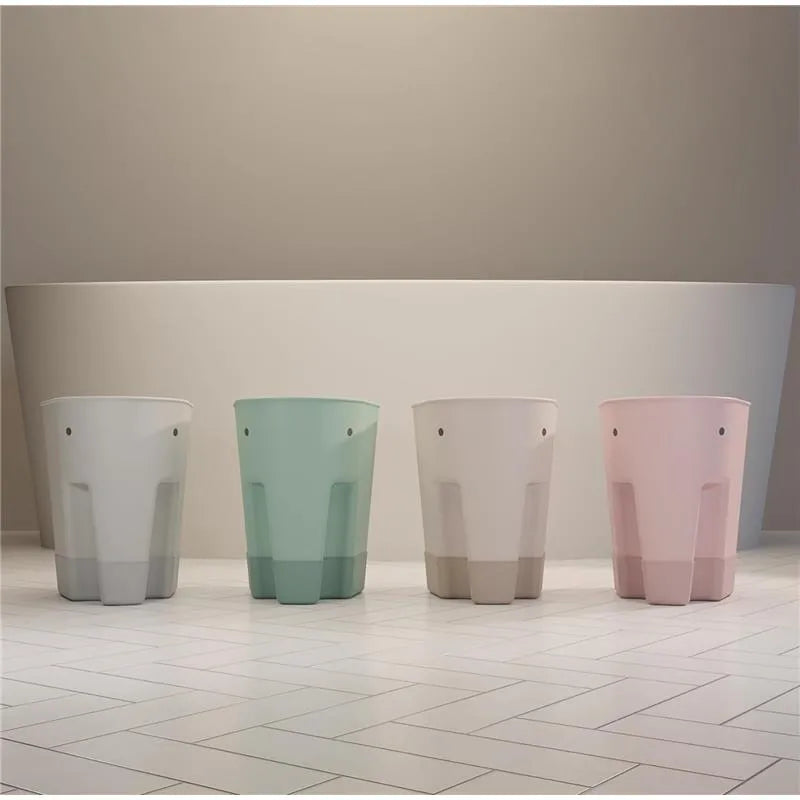 Grey Shnuggle Ellie Bath Toy Storage Scoop alongside mint, white, and pink storage scoops on a tiled floor.