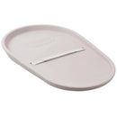 Squishy taupe baby changing diaper pad with a curved oval shape and a safety strap for securing the baby.