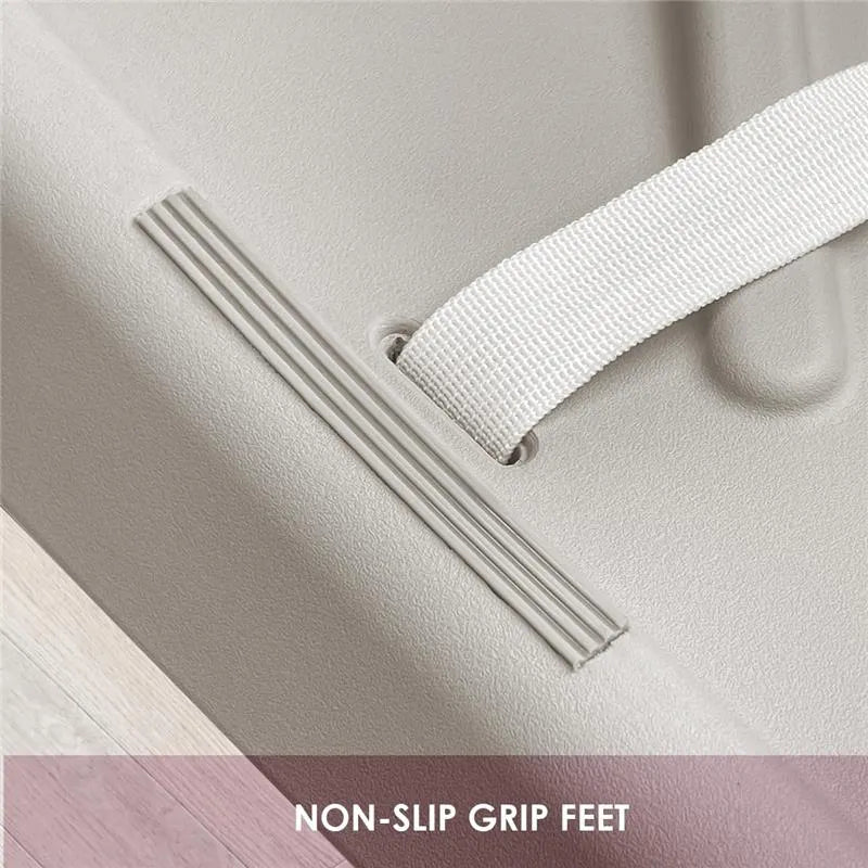 Taupe changing diaper pad corner showcasing non-slip grip feet and a white strap for secure placement.