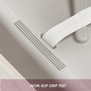 Taupe changing diaper pad corner showcasing non-slip grip feet and a white strap for secure placement.