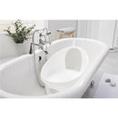 Toddler bath tub by Shnuggle in white and grey, placed inside a modern bathroom with a shiny faucet and a plant nearby.