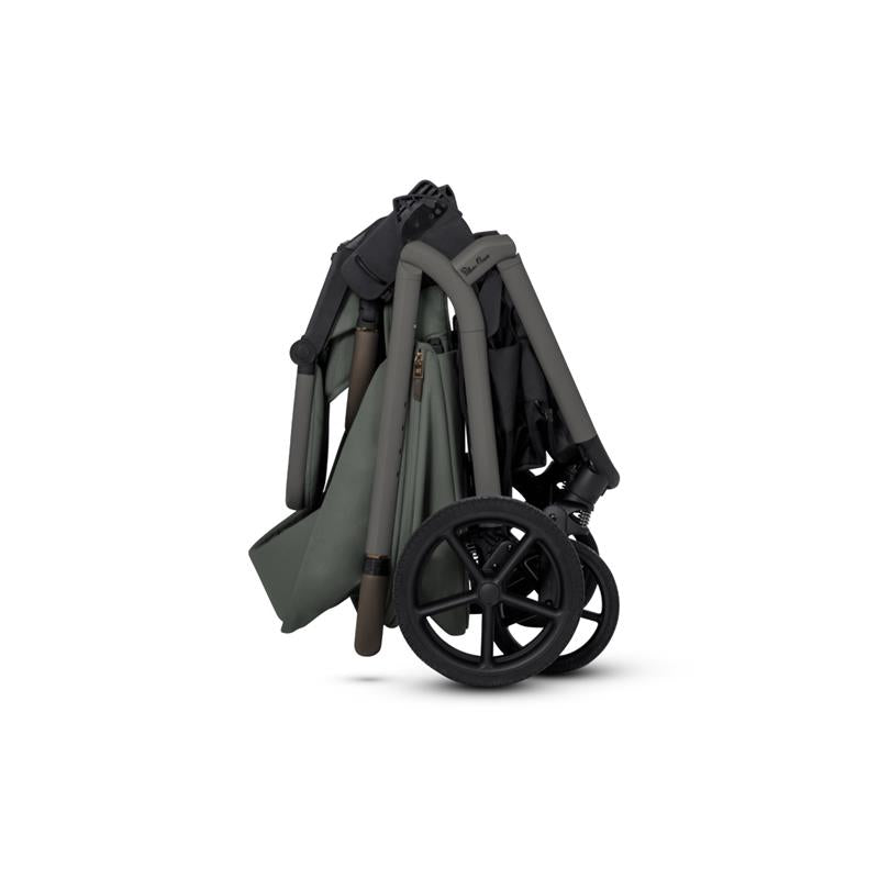 Compact Silver Cross Breez stroller in pewter color, folded for storage, showcasing its sleek design and wheels.