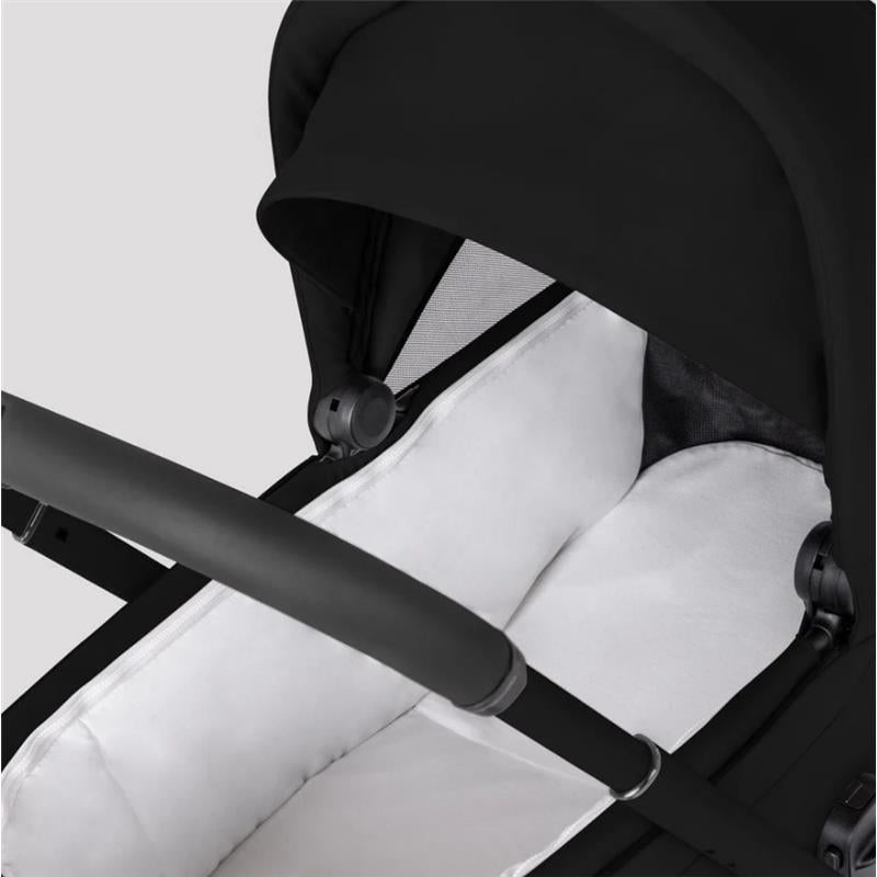 Silver Cross Breez Modular Stroller & Bassinet Bundle in Onyx, featuring a black canopy and white padded bassinet interior.