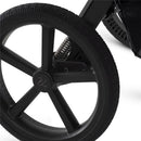 Close-up of a black wheel from the Silver Cross Cove 2 stroller, showing its stylish design and shock-absorbing spring.