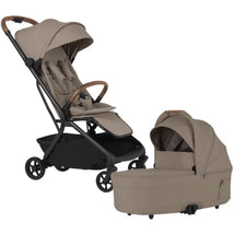 Silver Cross Nia Compact Travel Stroller in Champagne color beside matching bassinet, featuring a sleek design and flexible seating.