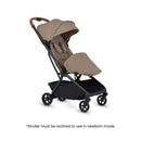 Silver Cross Nia Compact Travel Stroller in Champagne color, featuring a reclined seat, adjustable canopy, and a storage basket.